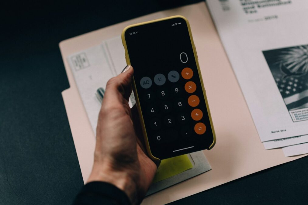Worker checking paycheck calculations, financial budget ledger, and health benefit documents