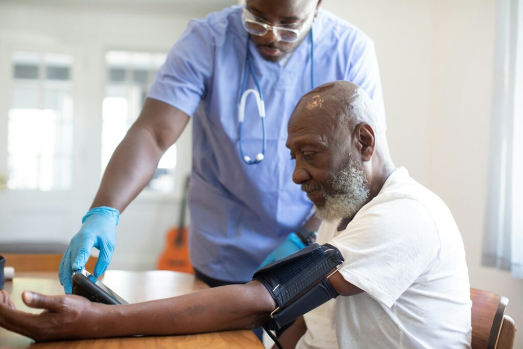Healthcare professional checking a patient's blood pressure at a community health screening