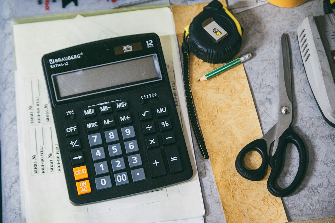 Calculator and papers on a desk for comparing quotes