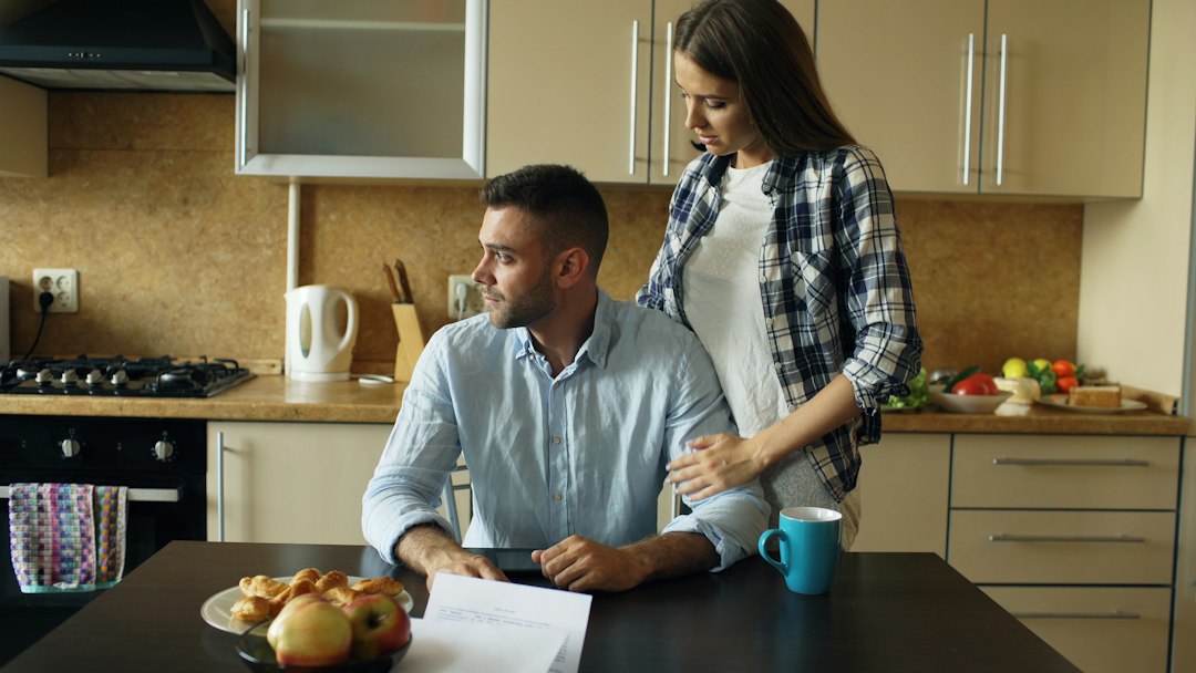 Couple reading bills together at the kitchen table