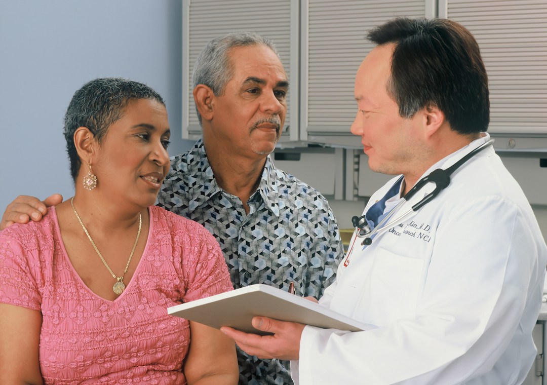 Doctor and patient discussing healthcare coverage and treatment