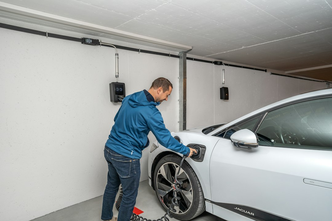 Home electric vehicle charger being plugged in