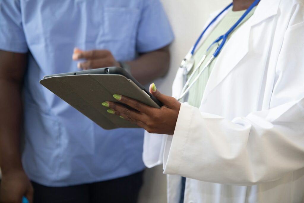 Doctor showing a patient healthcare information on a tablet
