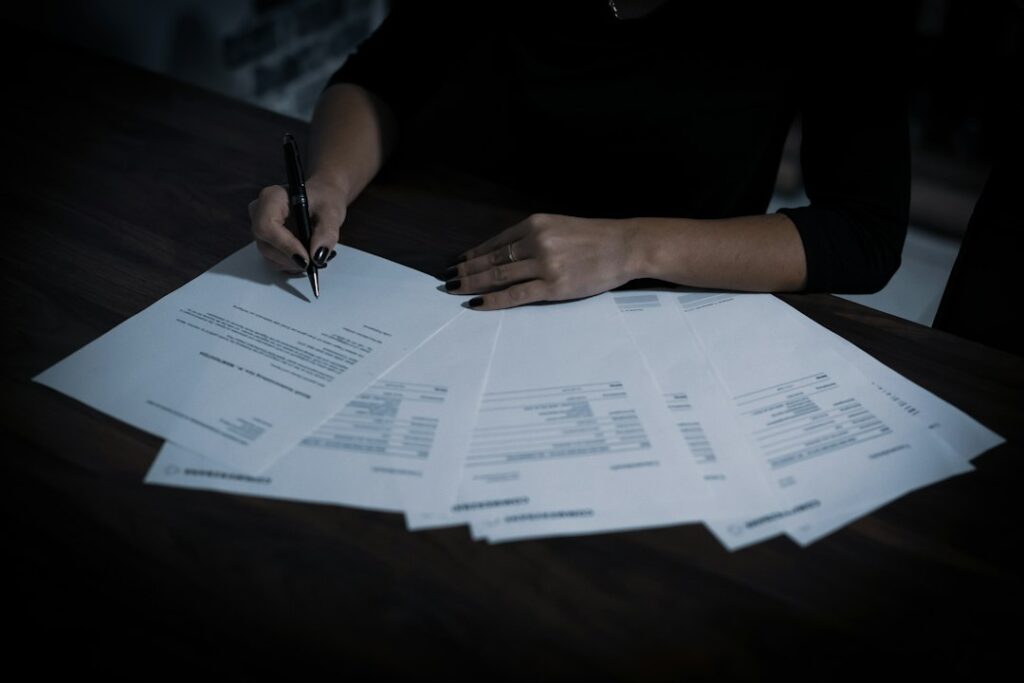 Person handling insurance paperwork and a phone