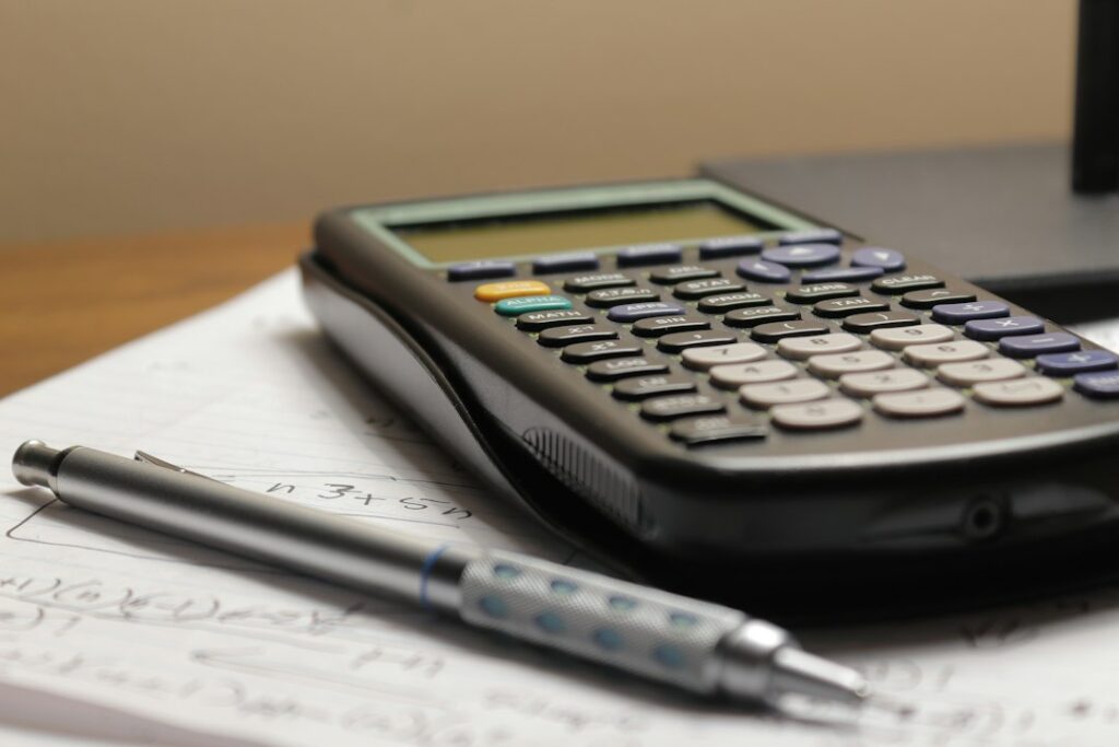 Person reviewing medical bills and insurance paperwork with a calculator
