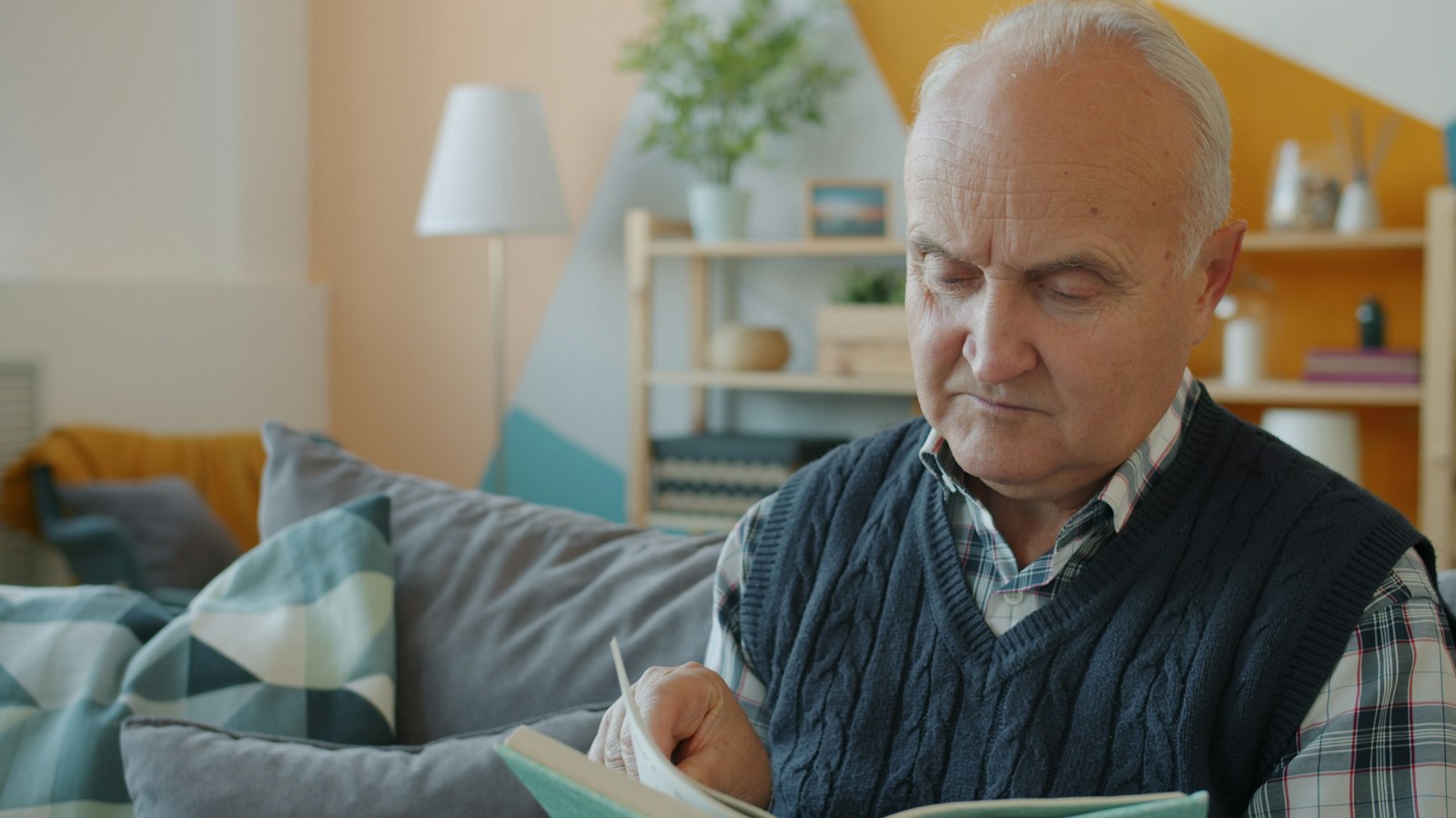 Older adult reading comfortably at home