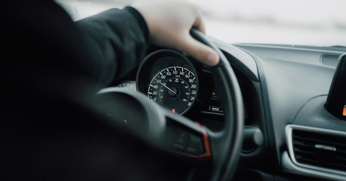 Person driving a car during the day
