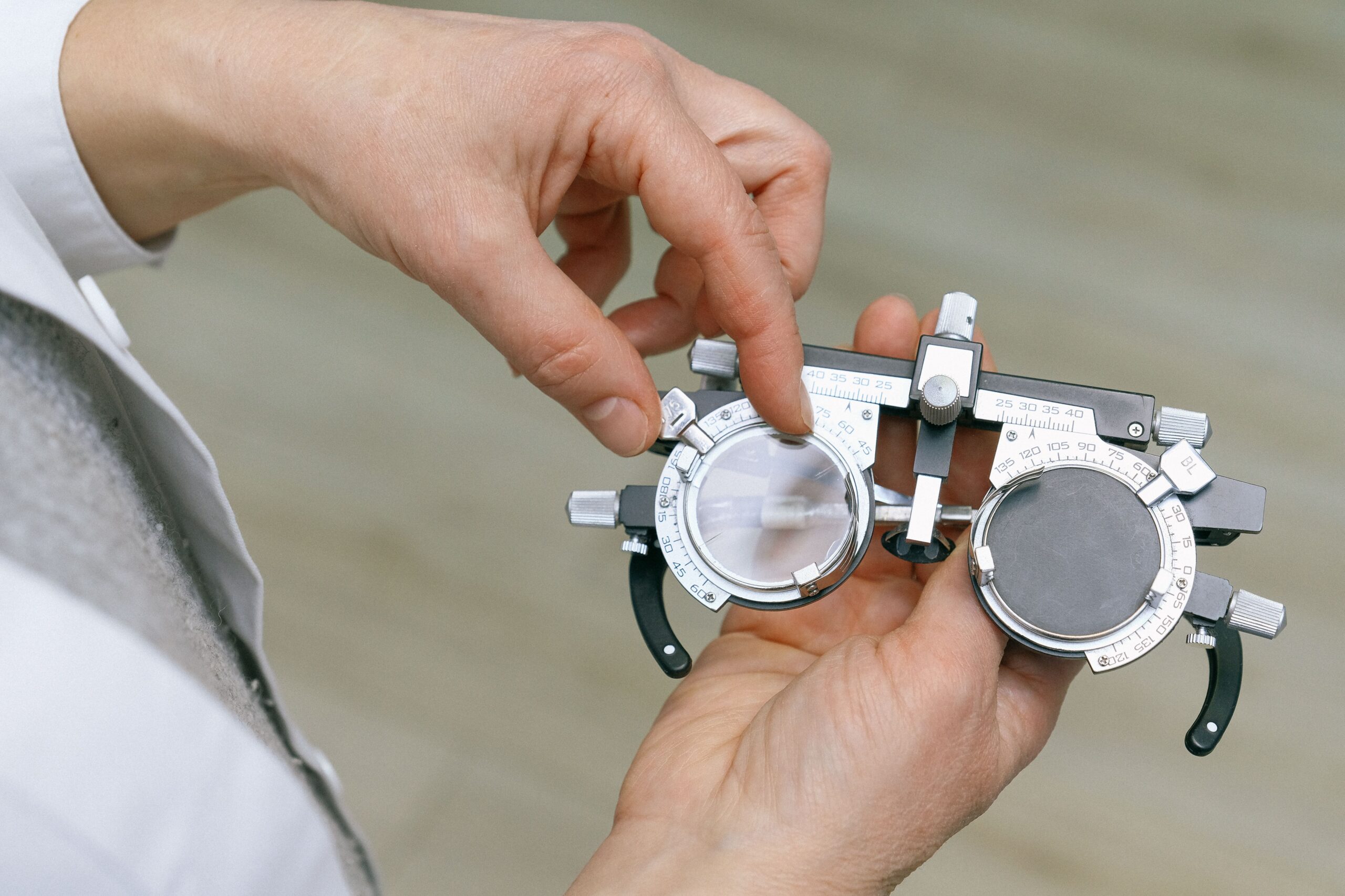 An eye care professional measuring test glasses during an eye exam