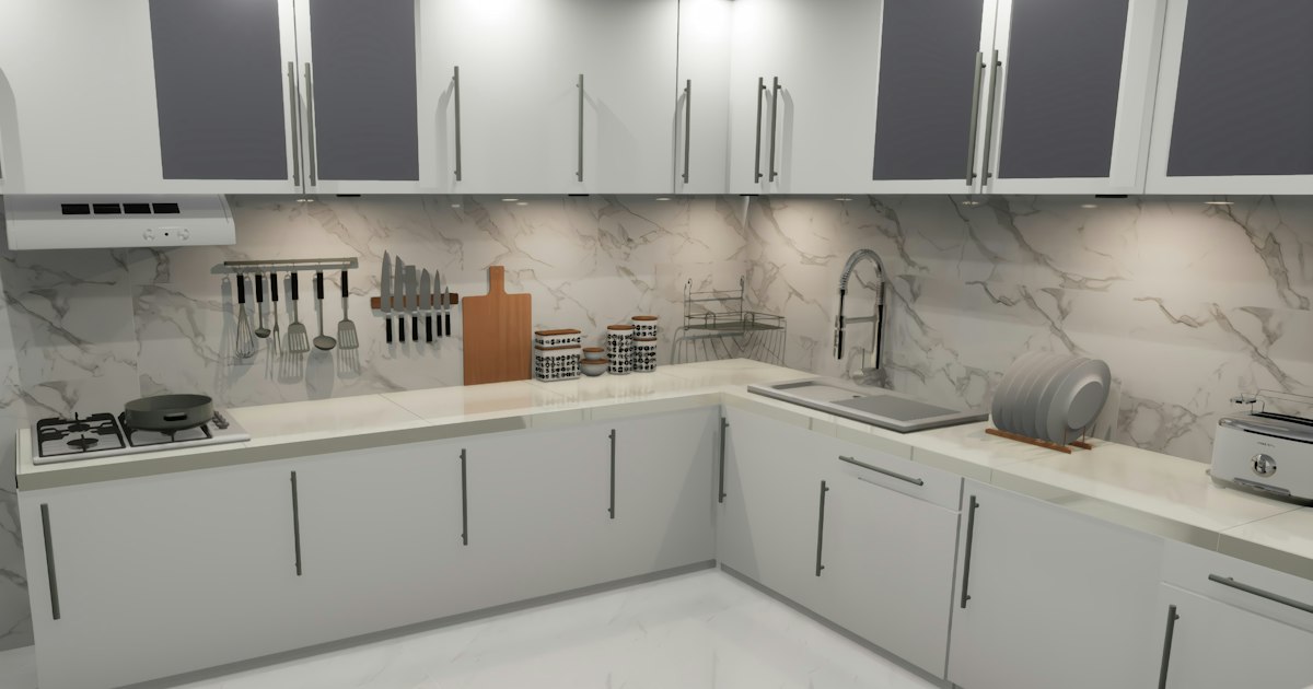 Bright kitchen with white cabinets and marble counters