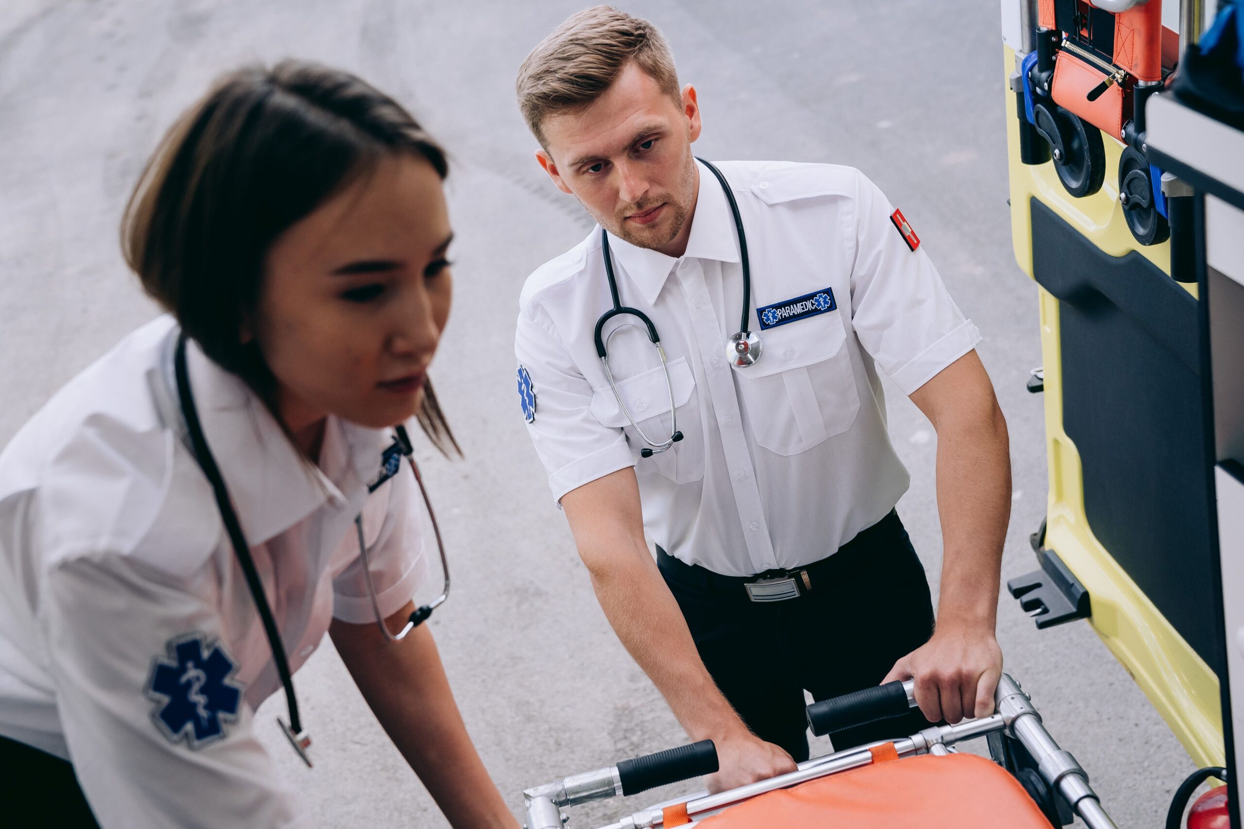 A male and a female paramedic standing together in uniform
