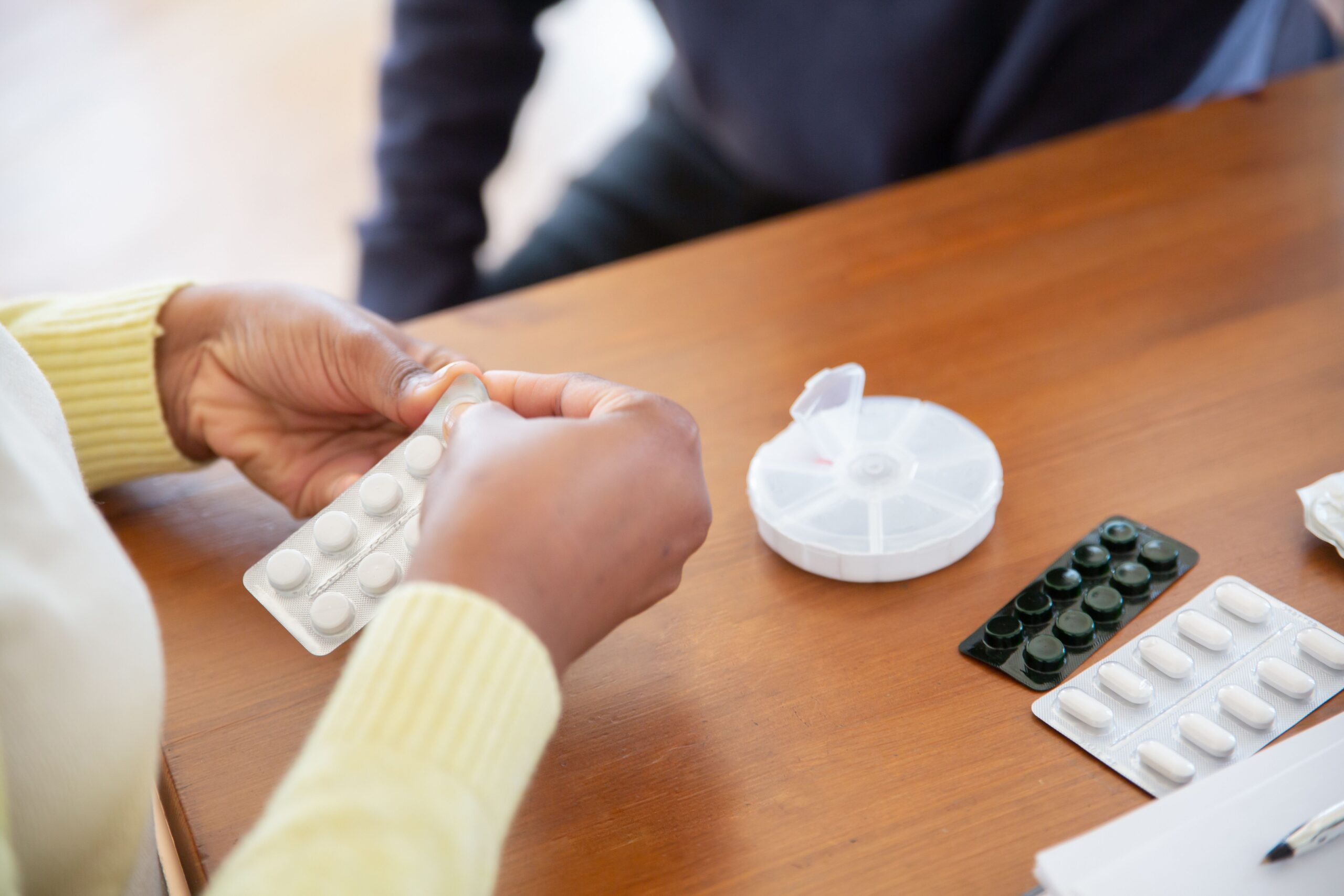 A person holding boxes of medicine bought at a pharmacy