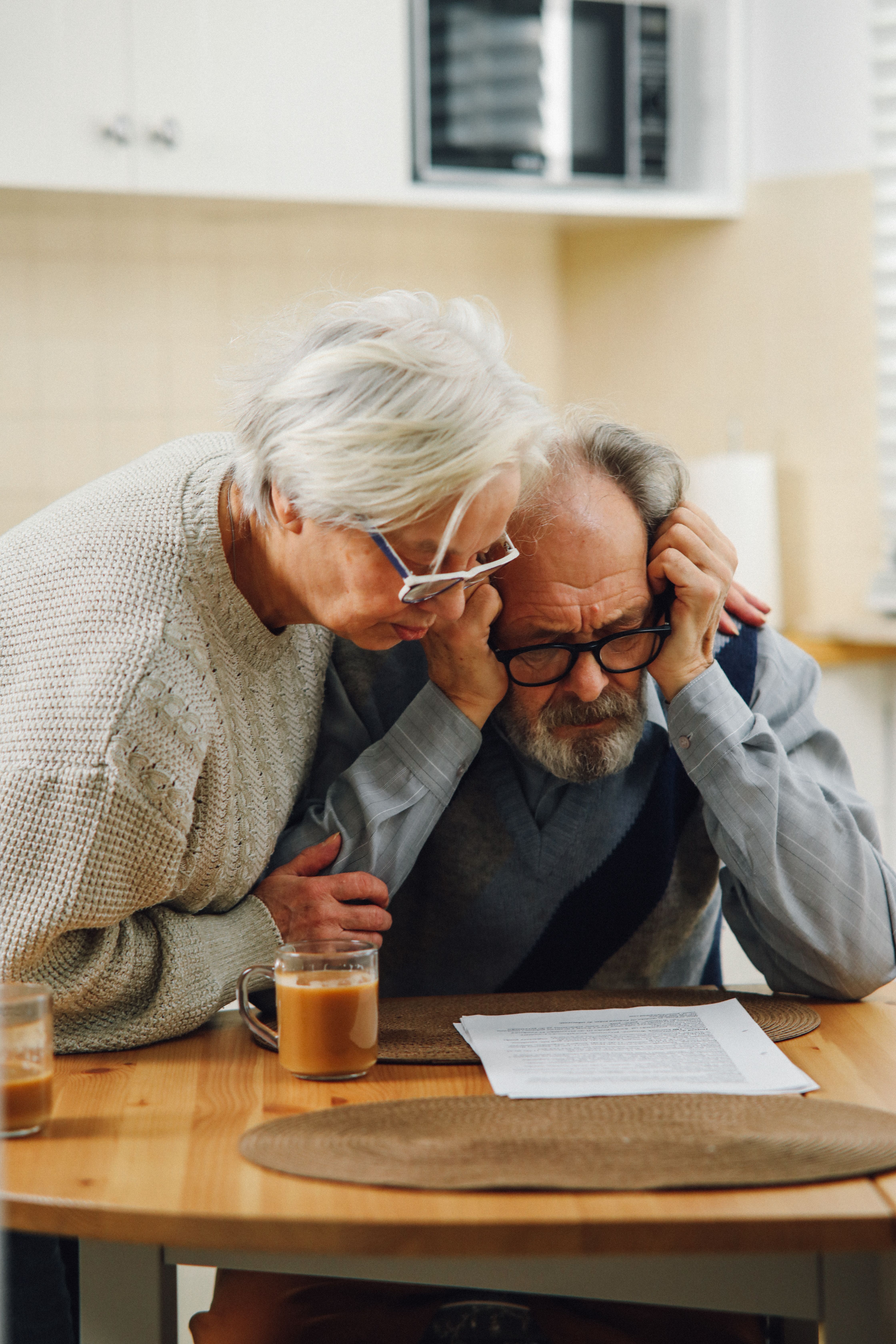 Older couple looking over Medicare paperwork at a table
